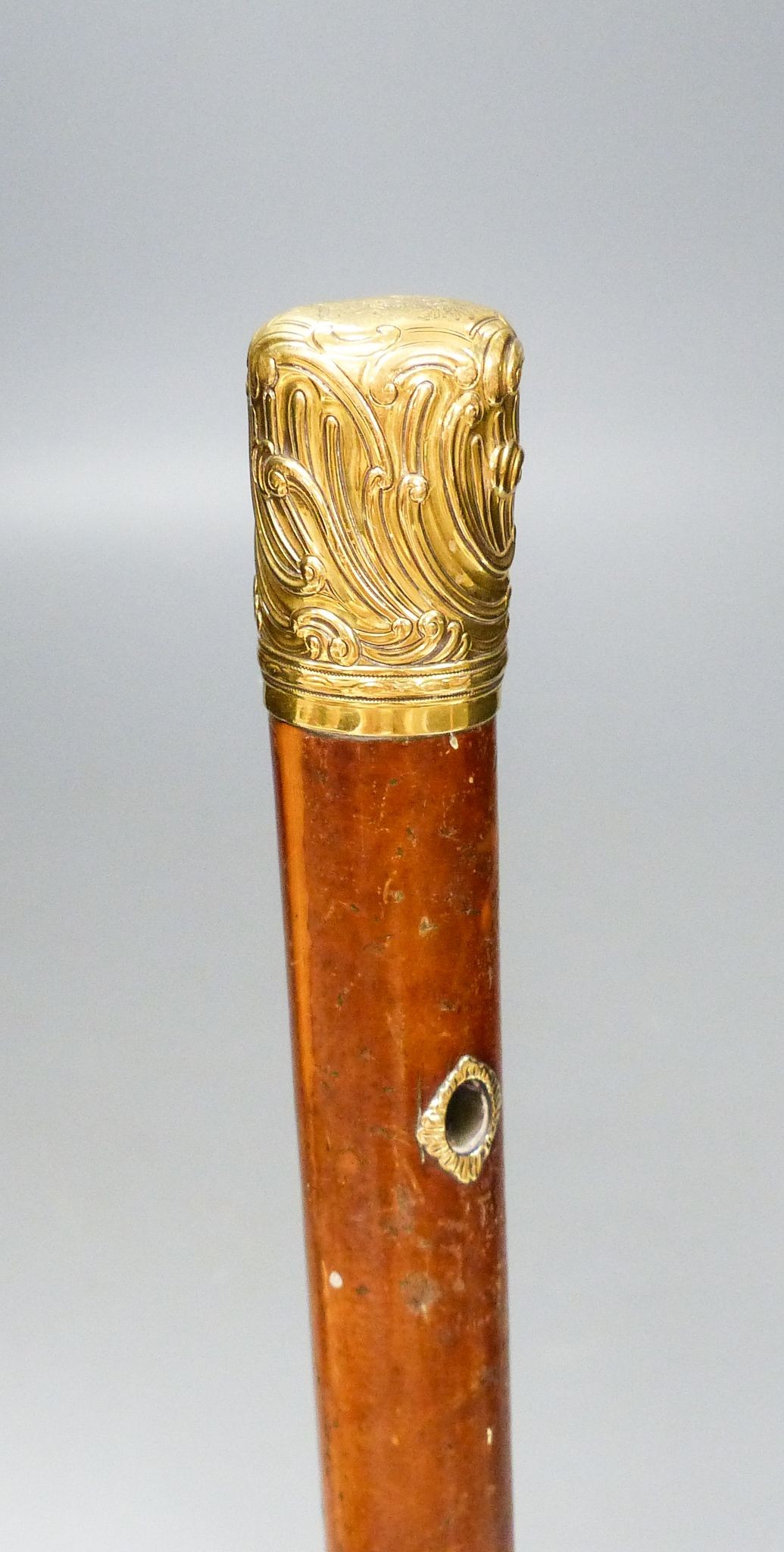 A long George III gold mounted malacca cane, 110.5 cm